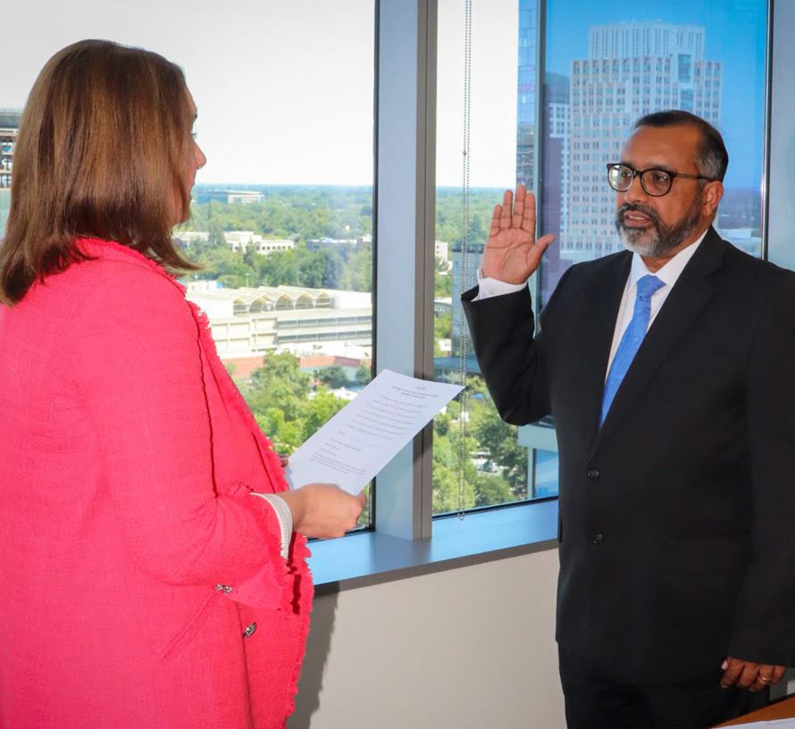 Reji Varghese getting sworn in by Board President Kristina D. Lawson